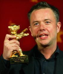 El director Michael Winterbottom recoge el Oso de Oro a la mejor película por «In this world», ayer en Berlín. REUTERS
