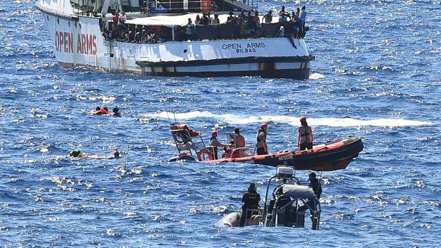Efectivos de los servicios de salvamento marítimo italiano auxilian a inmigrantes del Open Arms, este martes